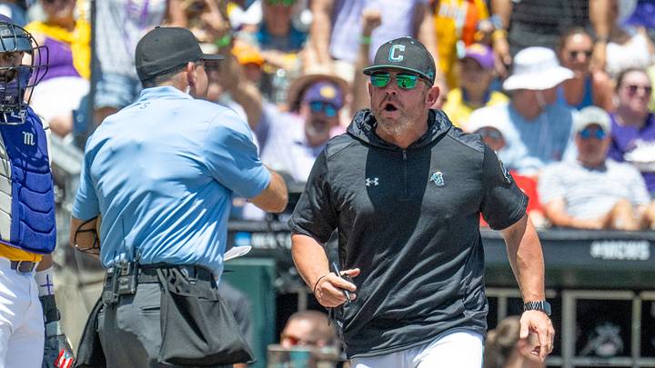 Jun 22, 2025; Omaha, Neb, USA;  Coastal Carolina Chanticleers head coach Kevin Schnall (9) gets thrown out of the game arguing with the umpires during the game against the LSU Tigers during the first inning at Charles Schwab Field. Mandatory Credit: Steven Branscombe-Imagn Images