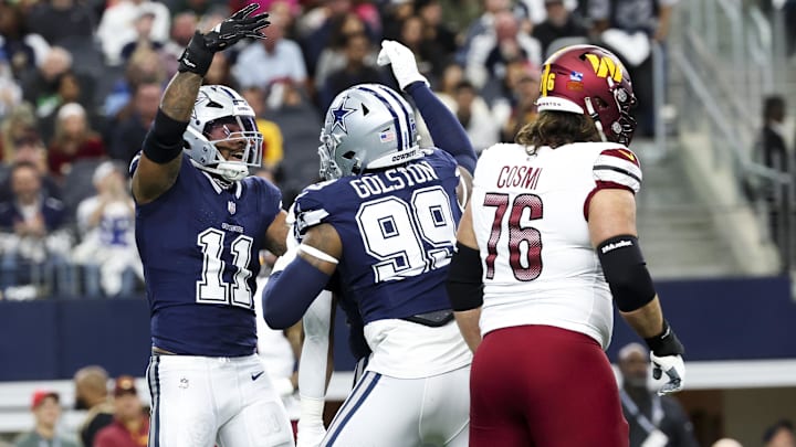 Dallas Cowboys linebacker Micah Parsons celebrates with Dallas Cowboys defensive end Chauncey Golston in front of Washington Commanders guard Sam Cosmi after a sack during the first quarter at AT&T Stadium. 