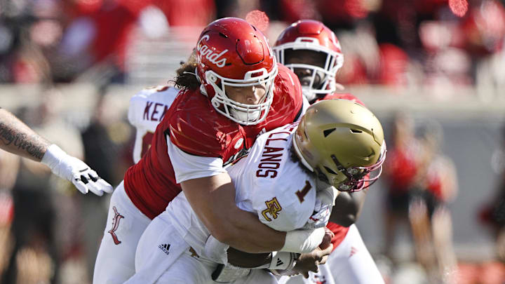 Sep 23, 2023; Louisville, Kentucky, USA; Louisville Cardinals defensive lineman Ashton Gillotte (9) sacks Boston College Eagles quarterback Thomas Castellanos (1) during the first half at L&N Federal Credit Union Stadium. Mandatory Credit: Jamie Rhodes-USA TODAY Sports