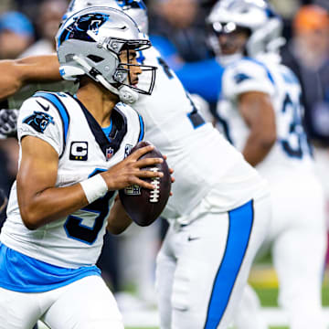 Sep 8, 2024; New Orleans, Louisiana, USA;  Carolina Panthers quarterback Bryce Young (9) scrambles to make a pass as New Orleans Saints defensive end Chase Young (99) rushes at him during the second half at Caesars Superdome. 