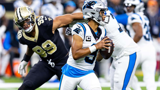 Carolina Panthers quarterback Bryce Young scrambles away from pressuring New Orleans Saints defensive end Chase Young (99)