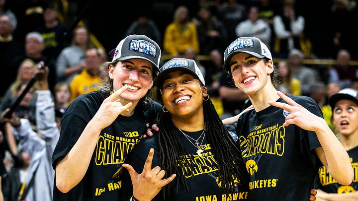 Iowa guards Kate Martin, left, and Caitlin Clark pose for a photo with Iowa assistant coach Raina Harmon after a NCAA Big Ten Conference women's basketball game against Michigan, Sunday, Feb. 27, 2022, at Carver-Hawkeye Arena in Iowa City, Iowa.