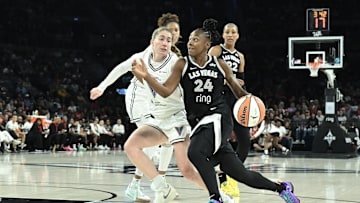 Aug 3, 2025; Las Vegas, Nevada, USA; Las Vegas Aces guard Jewell Loyd (24) drives past Golden State Valkyries guard Kate Martin (20) in the first quarter at Michelob Ultra Arena. 