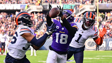 Justin Jefferson goes for the ball againt safety Jonathan Owens and cornerback Jaylon Johnson last year at Soldier Field.