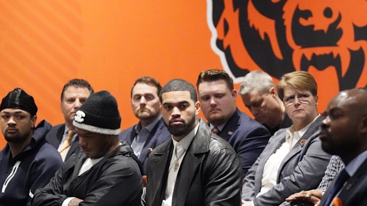 Jan 22, 2025; Lake Forest, IL, USA; Chicago Bears quarterback Caleb Williams to (C) listens as new head coach Ben Johnson (not pictured) answers questions during a introductory press conference at PNC Center. Mandatory Credit: David Banks-Imagn Images
