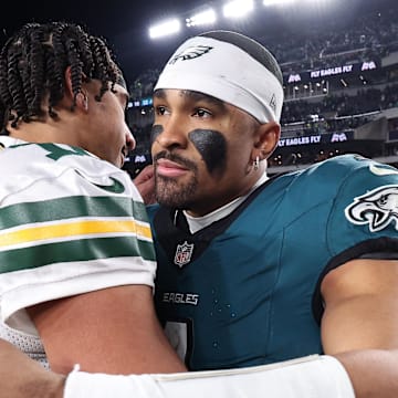 Green Bay Packers quarterback Jordan Love (10) and Philadelphia Eagles quarterback Jalen Hurts (1) embrace after last year's playoff game.