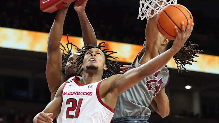Arkansas Razorbacks guard D.J. Wagner (21) goes under the hoop to beat two defenders and score two of his 13 points in a Nov. 25 rout of Maryland-Eastern Shore at Bud Walton Arena. Arkansas Razorbacks guard D.J. Wagner (21) goes under the hoop to beat two defenders and score two of his 13 points in a Nov. 25 rout of Maryland-Eastern Shore at Bud Walton Arena.