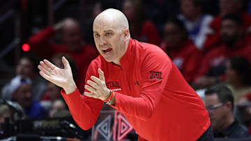 Utah Utes men's basketball coach Craig Smith cheers the team on from the sidelines.