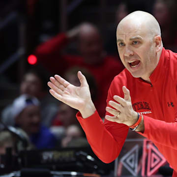 Utah Utes men's basketball coach Craig Smith cheers the team on from the sidelines.