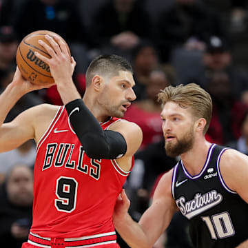 Mar 14, 2022; Sacramento, California, USA; Chicago Bulls center Nikola Vucevic (9) controls the ball against Sacramento Kings forward Domantas Sabonis (10) during the first quarter at Golden 1 Center. Mandatory Credit: Sergio Estrada-Imagn Images
