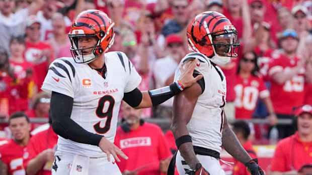 Cincinnati Bengals quarterback Joe Burrow (9) restrains wide receiver Ja'Marr Chase (1) after an altercation with officials d