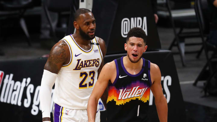 May 23, 2021; Phoenix, Arizona, USA; Phoenix Suns guard Devin Booker (1) reacts alongside Los Angeles Lakers forward LeBron James (23) in the first half during game one in the first round of the 2021 NBA Playoffs. at Phoenix Suns Arena. Mandatory Credit: Mark J. Rebilas-USA TODAY Sports
