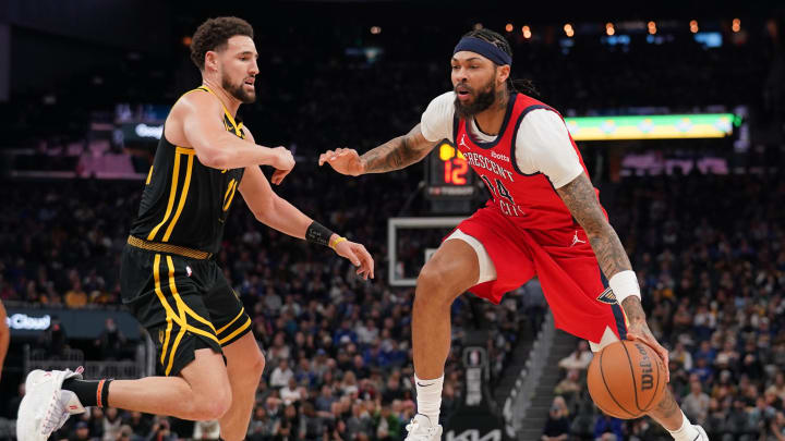 Jan 10, 2024; San Francisco, California, USA; New Orleans Pelicans forward Brandon Ingram (14) dribbles the ball next to Golden State Warriors guard Klay Thompson (11) in the third quarter at the Chase Center.