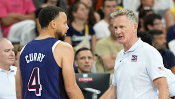 Jul 28, 2024; Villeneuve-d'Ascq, France; United States head coach Steve Kerr talks to shooting guard Stephen Curry (4) in the second quarter against Serbia during the Paris 2024 Olympic Summer Games at Stade Pierre-Mauroy. Mandatory Credit: John David Mercer-Imagn Images
