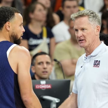 Jul 28, 2024; Villeneuve-d'Ascq, France; United States head coach Steve Kerr talks to shooting guard Stephen Curry (4) in the second quarter against Serbia during the Paris 2024 Olympic Summer Games at Stade Pierre-Mauroy. Mandatory Credit: John David Mercer-Imagn Images
