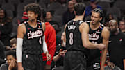 Apr 1, 2025; Atlanta, Georgia, USA; Portland Trail Blazers guard Matisse Thybulle (4) and forwards Deni Avdija (8) and  Toumani Camara (33) react late in the game against the Atlanta Hawks during the second half at State Farm Arena. Mandatory Credit: Dale Zanine-Imagn Images