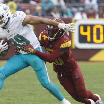 Miami Dolphins tight end Julian Hill runs with the ball as Washington Commanders safety Jartavius Martin (20) makes the tackle during the fourth quarter at FedExField last December.