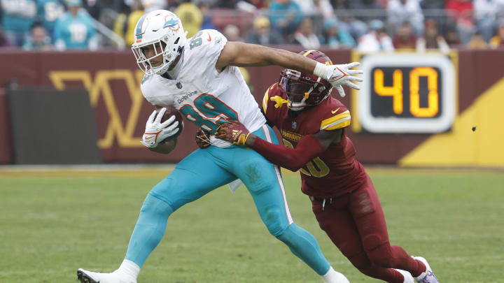 Miami Dolphins tight end Julian Hill runs with the ball as Washington Commanders safety Jartavius Martin (20) makes the tackle during the fourth quarter at FedExField last December.