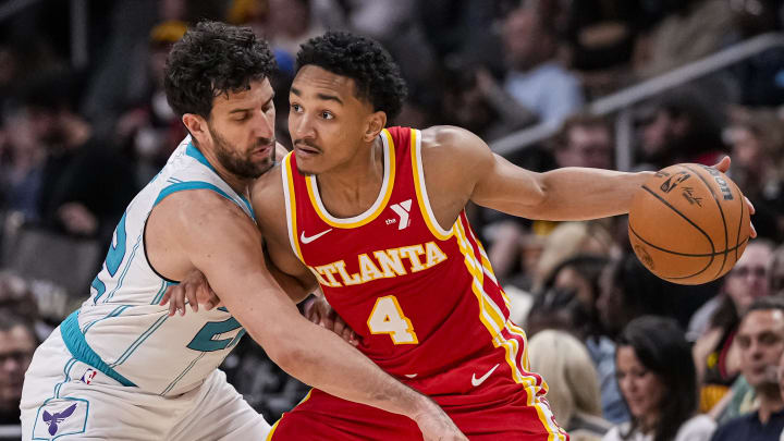 Apr 10, 2024; Atlanta, Georgia, USA; Atlanta Hawks guard Kobe Bufkin (4) is defended by Charlotte Hornets guard Vasilije Micic (22) during the second half at State Farm Arena. Mandatory Credit: Dale Zanine-USA TODAY Sports