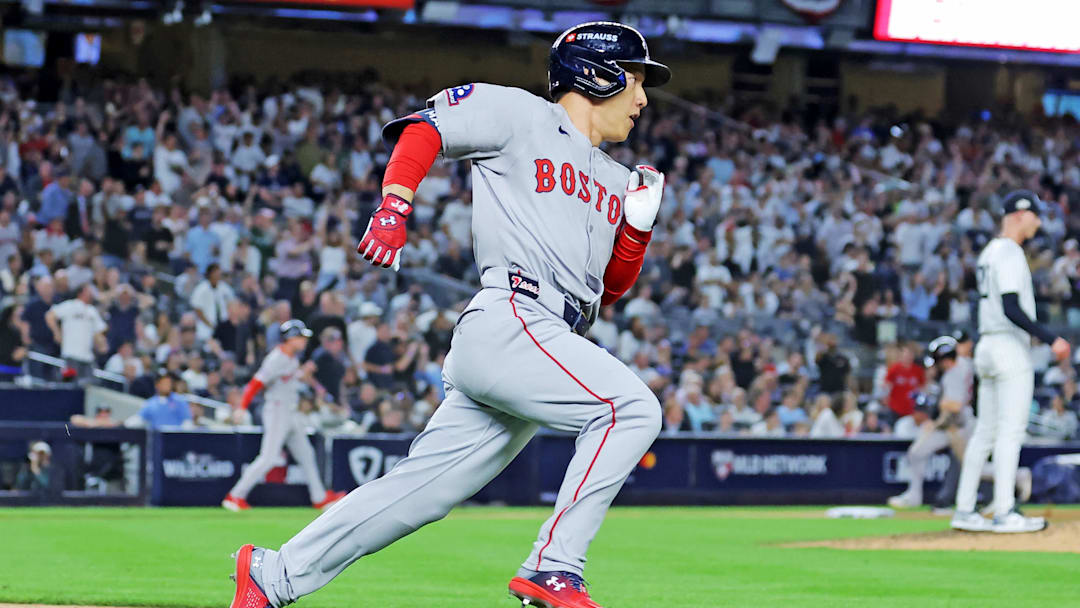 Sep 30, 2025; Bronx, New York, USA; Boston Red Sox outfielder Masataka Yoshida (7) hits a two run RBI during the seventh inning against the New York Yankees during game one of the Wildcard round for the 2025 MLB playoffs at Yankee Stadium. Mandatory Credit: Brad Penner-Imagn Images