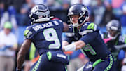 Nov 9, 2025; Seattle, Washington, USA; Seattle Seahawks quarterback Sam Darnold (14) hands the ball off to Seattle Seahawks running back Kenneth Walker III (9) during the first quarter at Lumen Field. Mandatory Credit: Kevin Ng-Imagn Images