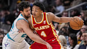 Apr 10, 2024; Atlanta, Georgia, USA; Atlanta Hawks guard Kobe Bufkin (4) is defended by Charlotte Hornets guard Vasilije Micic (22) during the second half at State Farm Arena. Mandatory Credit: Dale Zanine-Imagn Images