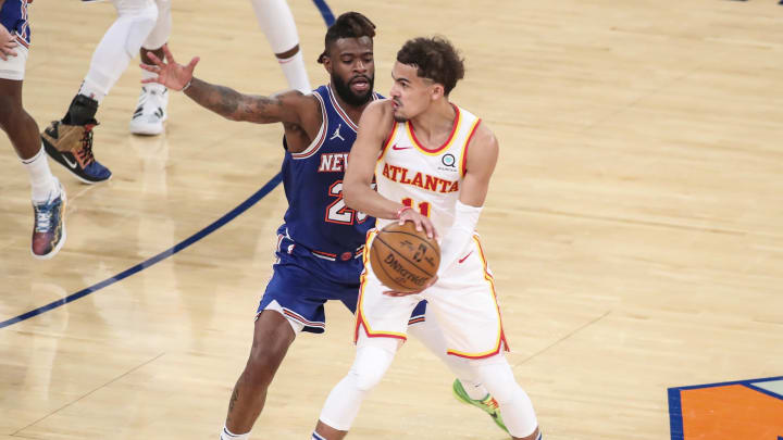 Jun 2, 2021; New York, New York, USA; Atlanta Hawks guard Trae Young (11) looks to make a pass while being guarded by New York Knicks forward Reggie Bullock (25) in the second quarter during game five in the first round of the 2021 NBA Playoffs at Madison Square Garden. Mandatory Credit: Wendell Cruz-USA TODAY Sports