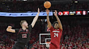 Mar 8, 2025; Louisville, Kentucky, USA;  Louisville Cardinals guard Chucky Hepburn (24) shoots against Stanford Cardinal forward Aidan Cammann (52) during the second half at KFC Yum! Center. Louisville defeated Stanford 68-48. Mandatory Credit: Jamie Rhodes-Imagn Images