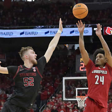 Mar 8, 2025; Louisville, Kentucky, USA;  Louisville Cardinals guard Chucky Hepburn (24) shoots against Stanford Cardinal forward Aidan Cammann (52) during the second half at KFC Yum! Center. Louisville defeated Stanford 68-48. Mandatory Credit: Jamie Rhodes-Imagn Images