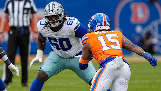 Dallas Cowboys offensive tackle Tyler Guyton (60) sets to block Denver Broncos linebacker Nik Bonitto (15).