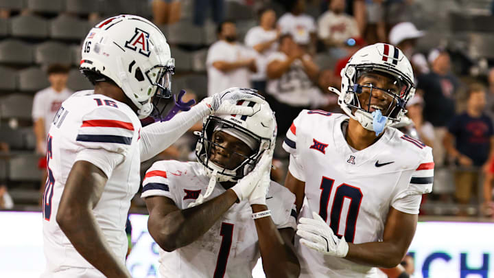 Aug 31, 2024; Tucson, Arizona, USA; Arizona Wildcats running back Jacory Croskey-Merritt (1) celebrates touchdown with Arizona Wildcats wide receiver Chris Hunter (16) and Arizona Wildcats wide receiver Malachi Riley (10) during fourth quarter at Arizona Stadium. Mandatory Credit: Aryanna Frank-Imagn Images