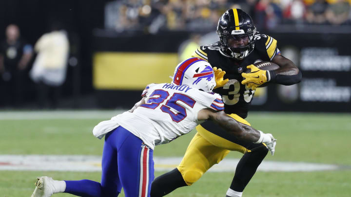 Aug 17, 2024; Pittsburgh, PA;  Pittsburgh Steelers running back La'Mical Perine (38) runs the ball against Buffalo Bills cornerback Daequan Hardy (25) during the third quarter at Acrisure Stadium. Buffalo won 9-3. 