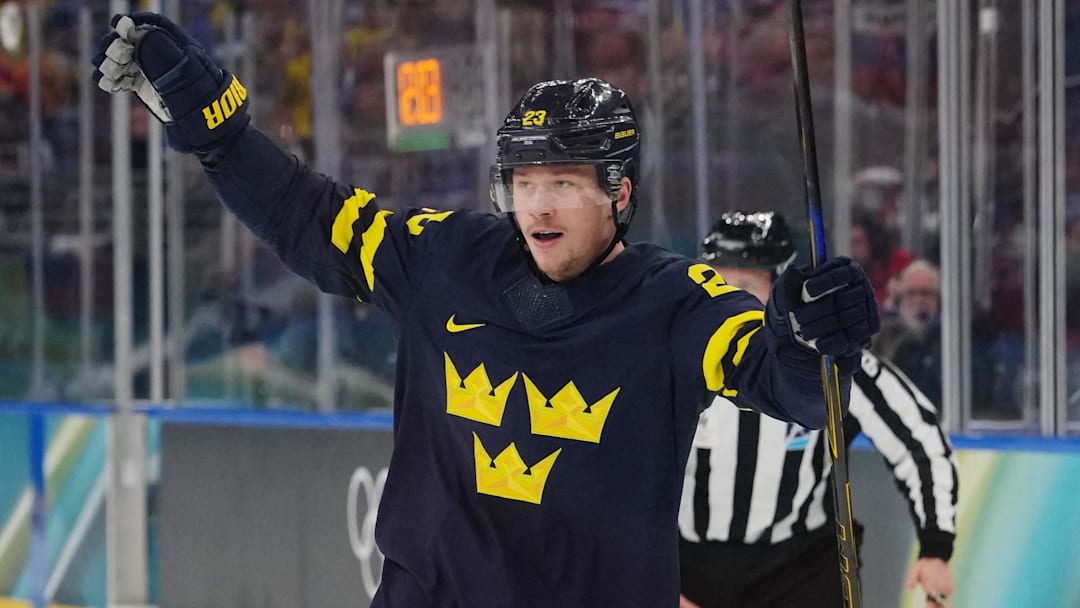 Feb 14, 2026; Milan, Italy; Lucas Raymond of Sweden celebrates after Elias Pettersson of Sweden scores their fourth goal during a Group B men's ice hockey game during the Milano Cortina 2026 Olympic Winter Games at Milano Santagiulia Ice Hockey Arena. Mandatory Credit: James Lang-Imagn Images