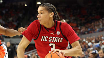 Dec 3, 2025; Auburn, Alabama, USA;  NC State Wolfpack guard Matt Able (3) drives against Auburn Tigers guard Keyshawn Hall (7) during the first half at Neville Arena. Mandatory Credit: John Reed-Imagn Images