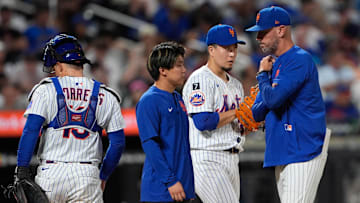 New York Mets pitching coach Jeremy Hefner (65) speaks with New York Mets pitcher Kodai Senga (34) during the third inning against the Philadelphia Phillies at Citi Field on Aug. 25.