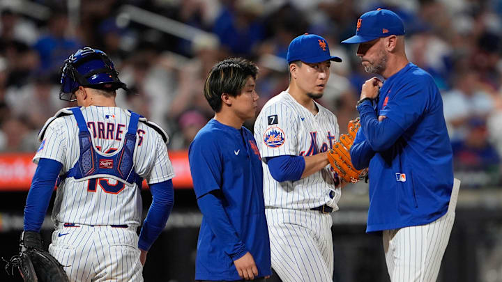 New York Mets pitching coach Jeremy Hefner (65) speaks with New York Mets pitcher Kodai Senga (34) during the third inning against the Philadelphia Phillies at Citi Field on Aug. 25.