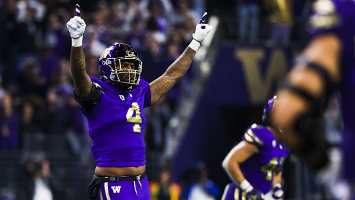 Oct 21, 2023; Seattle, Washington, USA; Washington Huskies defensive end Zion Tupuola-Fetui (4) celebrates following a turnover on downs by the Arizona State Sun Devils during the fourth quarter at Alaska Airlines Field at Husky Stadium. Mandatory Credit: Joe Nicholson-Imagn Images