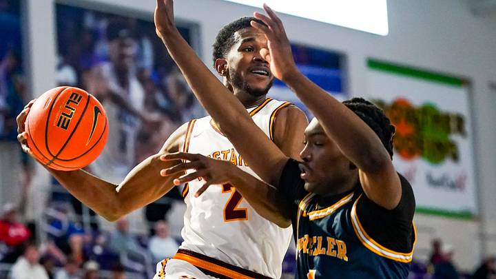 Bishop McNamara Mustangs guard Prince-Alexander Moody (2) looks to pass as Wheeler Wildcats forward Jaron Saulsberry (1) guards him during the first quarter of a City of Palms Classic first round game at Suncoast Credit Union Arena in Fort Myers, Fla., on Friday, Dec. 19, 2025.