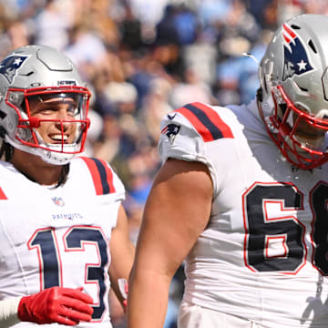 Oct 19, 2025; Nashville, Tennessee, USA; New England Patriots running back Rhamondre Stevenson (38) celebrates with offensive tackle Will Campbell (66) and wide receiver Mack Hollins (13) after scoring a touchdown against the Tennessee Titans during the second half at Nissan Stadium. Mandatory Credit: Steve Roberts-Imagn Images
