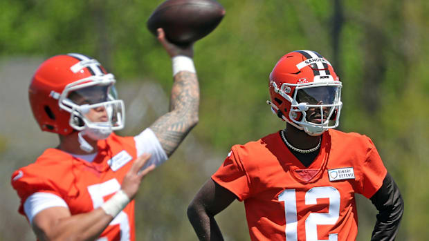 Cleveland Browns quarterback Shedeur Sanders (12) watches as quarterback Dillon Gabriel (5) throws during NFL rookie minicamp