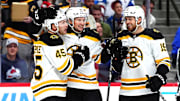 Oct 16, 2024; Denver, Colorado, USA; Boston Bruins left wing Cole Koepke (45) celebrates his goal with defenseman Andrew Peeke (52) and center John Beecher (19) in the first period against the Colorado Avalanche at Ball Arena. Mandatory Credit: Ron Chenoy-Imagn Images