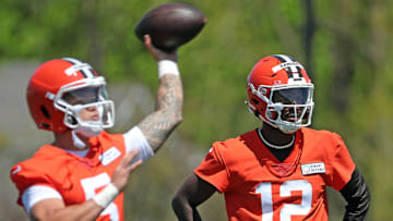 Cleveland Browns quarterback Shedeur Sanders (12) watches as quarterback Dillon Gabriel (5) throws during NFL rookie minicamp at the Cleveland Browns training facility on Friday, May 9, 2025, in Berea, Ohio.