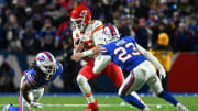 Jan 21, 2024; Orchard Park, NY; Kansas City Chiefs quarterback Patrick Mahomes (15) rushes the ball past Buffalo Bills safety Micah Hyde (23) in the second half of the 2024 AFC divisional round game at Highmark Stadium 