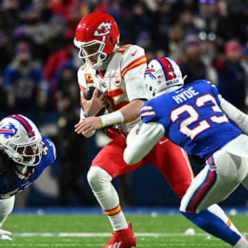 Jan 21, 2024; Orchard Park, NY; Kansas City Chiefs quarterback Patrick Mahomes (15) rushes the ball past Buffalo Bills safety Micah Hyde (23) in the second half of the 2024 AFC divisional round game at Highmark Stadium 