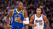 Oct 9, 2024; Sacramento, California, USA; Golden State Warriors forward Jonathan Kuminga (00) and Sacramento Kings forward Keegan Murray (13) jog up the court during the first quarter at Golden 1 Center. Mandatory Credit: Ed Szczepanski-Imagn Images