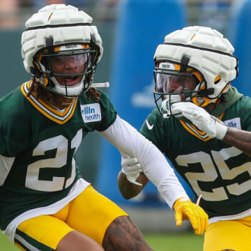 Green Bay Packers cornerbacks Eric Stokes (21) and Keisean Nixon (25) run through a drill on Wednesday at training camp.