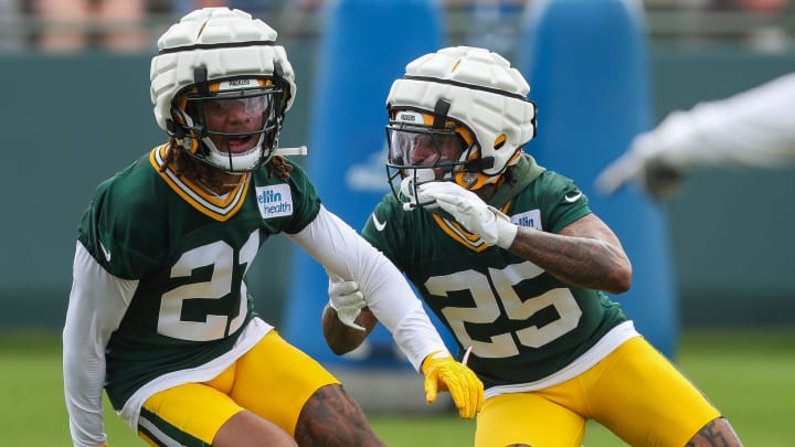 Green Bay Packers cornerbacks Eric Stokes (21) and Keisean Nixon (25) run through a drill at training camp.