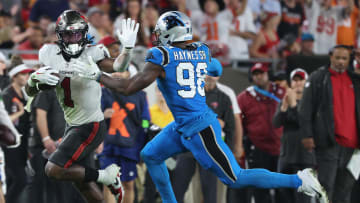 Dec 3, 2023; Tampa, Florida, USA; Tampa Bay Buccaneers running back Rachaad White (1) stiff arms Carolina Panthers linebacker Marquis Haynes Sr. (98)  during the second half at Raymond James Stadium. Mandatory Credit: Kim Klement Neitzel-USA TODAY Sports