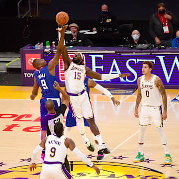 Los Angeles Clippers center Serge Ibaka (9) and Los Angeles Lakers center Montrezl Harrell (15) go up for a jump ball to start the game at Staples Center. 