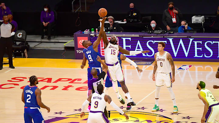 Los Angeles Clippers center Serge Ibaka (9) and Los Angeles Lakers center Montrezl Harrell (15) go up for a jump ball to start the game at Staples Center. 